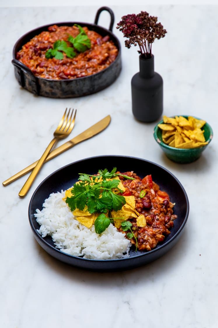 Rask chili con carne med jasminris, tortillachips, lettrømme, koriander og lime