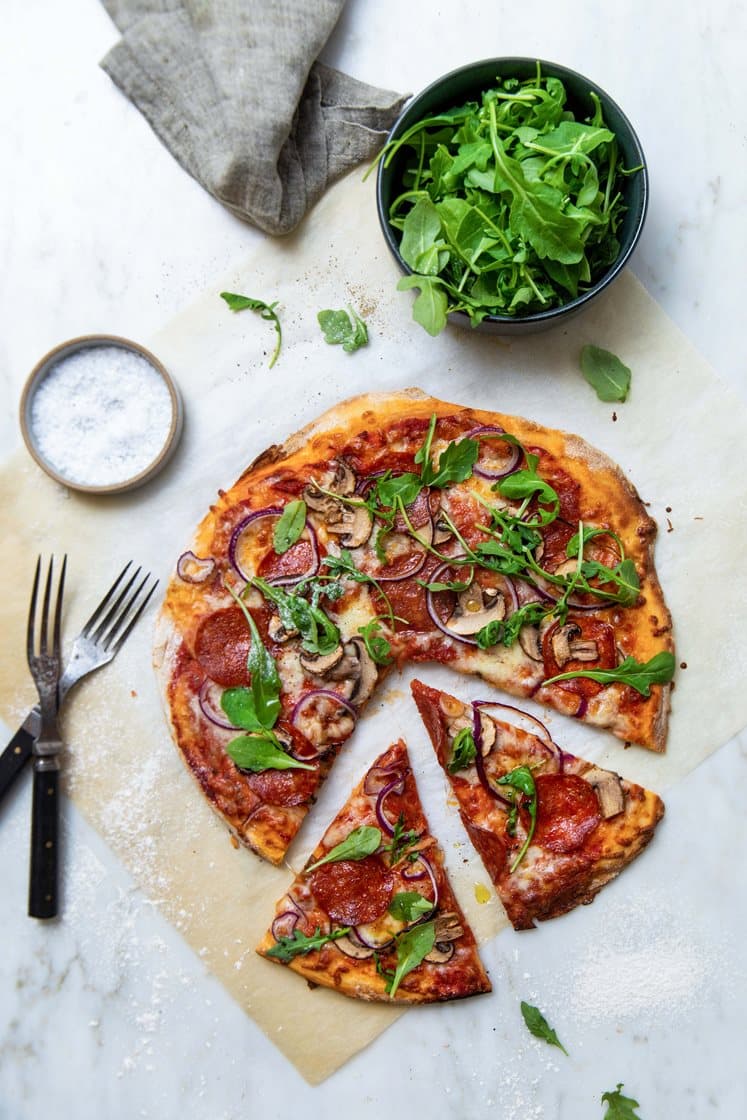 Pepperonipizza med aromasopp og rødløk, toppet med ruccolasalat
