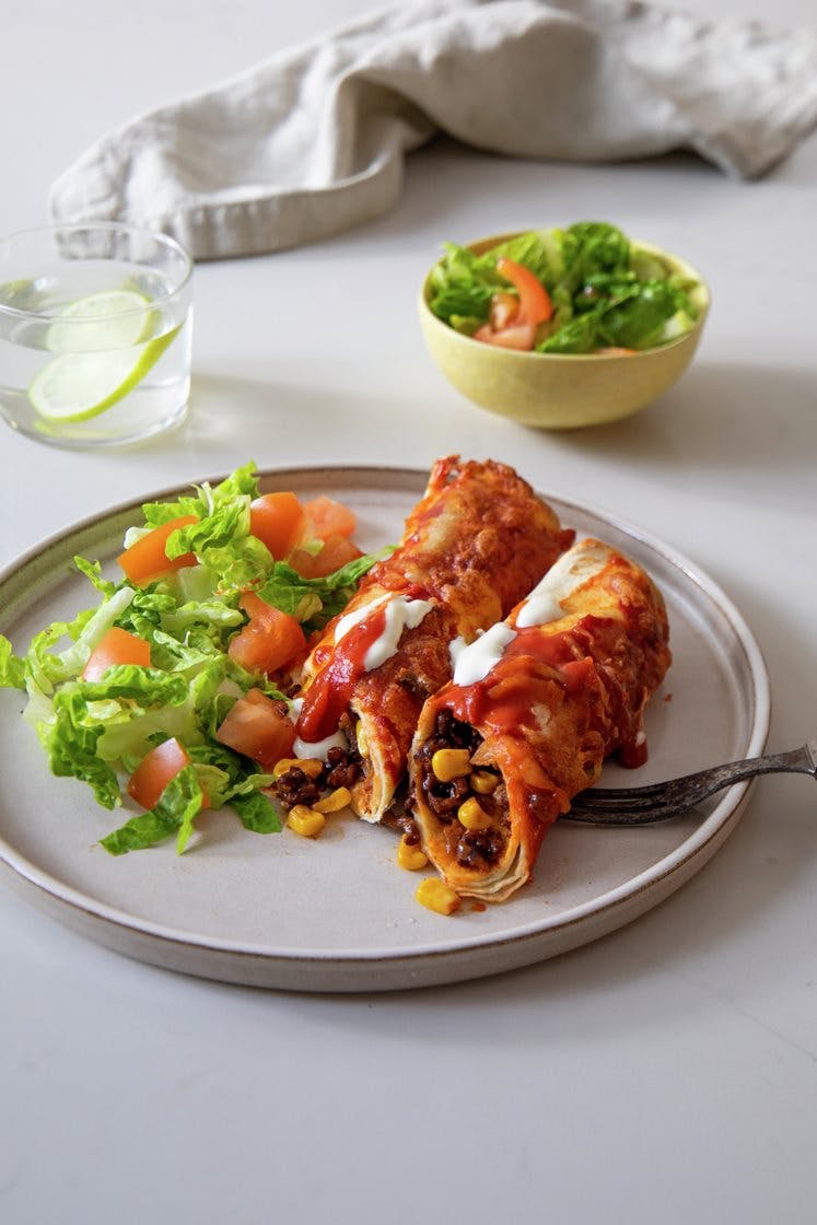 Enchiladas med kjøttdeig, tomatsaus og ost, servert med frisk salat